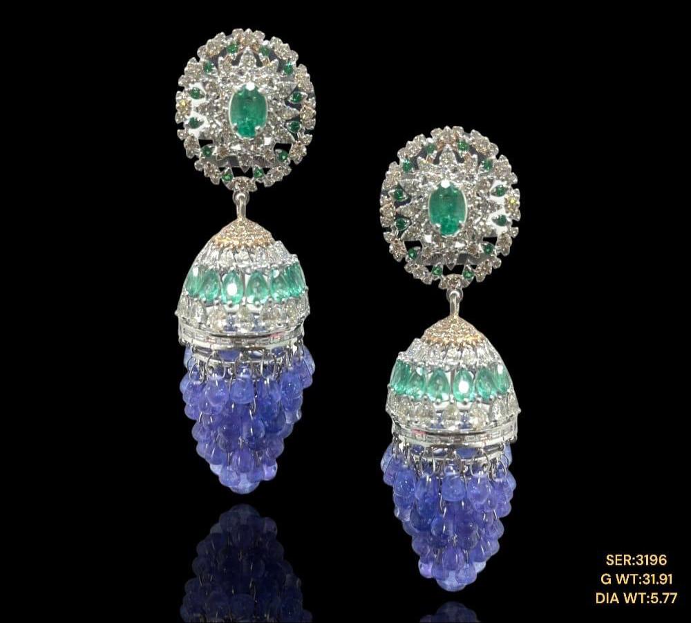 Vibrant tanzanite’s and emeralds studded with sparkling natural diamonds set in 14kt gold