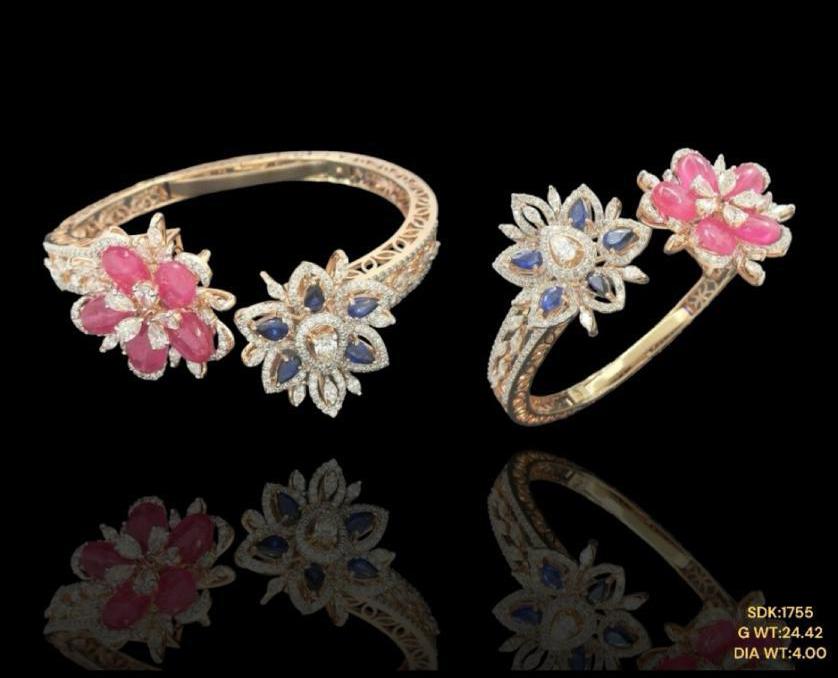 Elegant 14kt gold braclet showcasing a radiant ruby and tanzanite framed by shimmering diamond