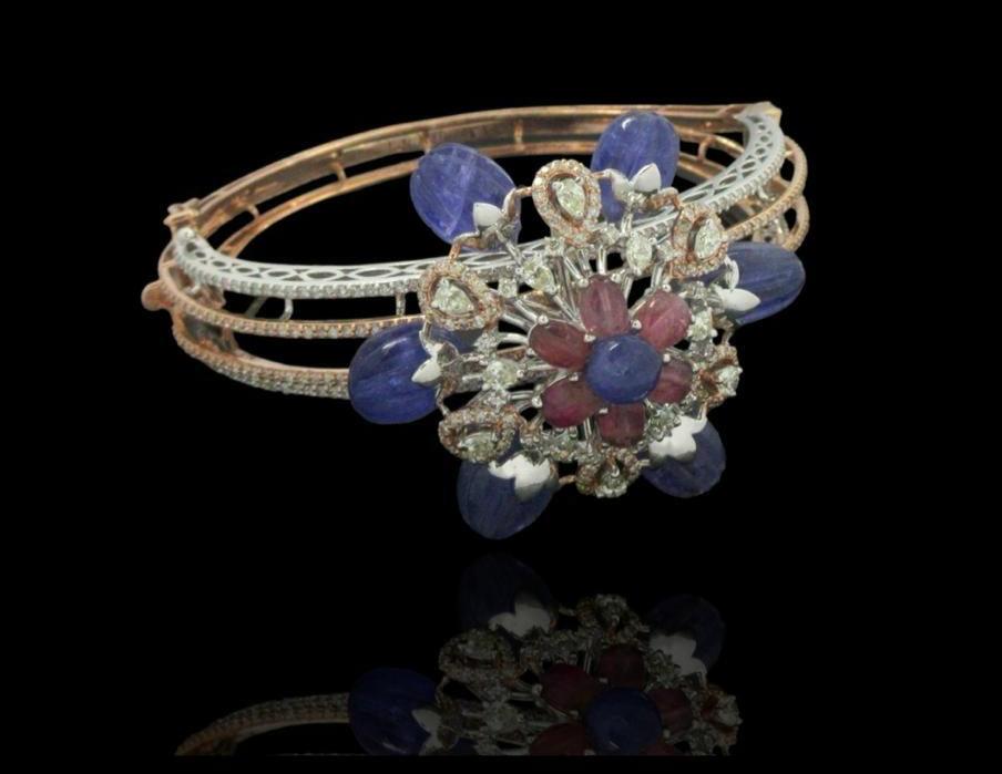 Vibrant diamond bracelet surrounded by saphhire and emerald beads set in timeless 14kt gold