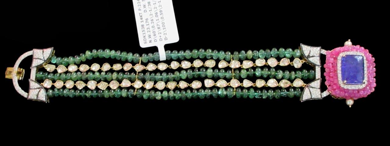 A spohistocated 14kt gold bracelet featuring a dazzling gemstones with uncut diamonds