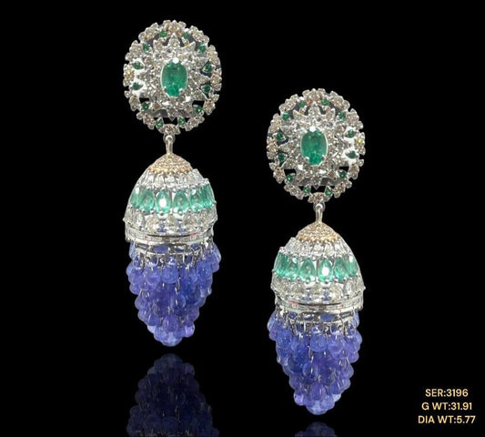 Vibrant tanzanite’s and emeralds studded with sparkling natural diamonds set in 14kt gold